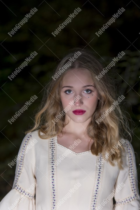 Portrait of a blonde young woman dressed in a vintage dress