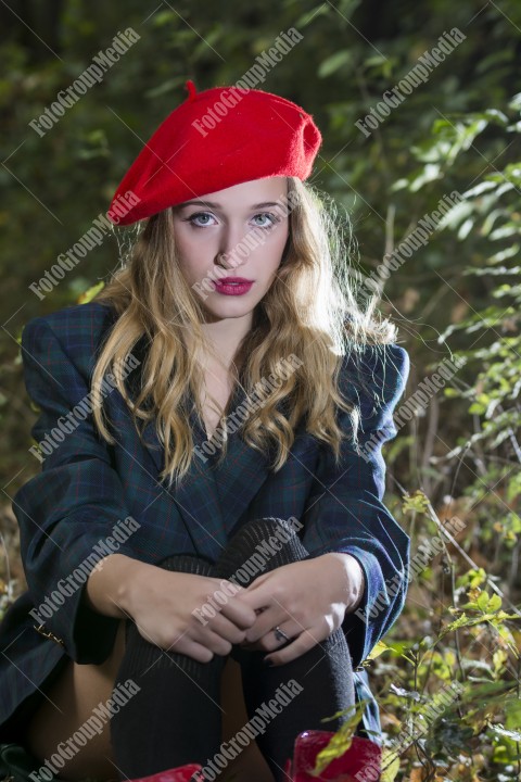 Young woman looking happy in forest in an autumn day