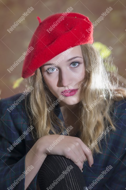 Close up portrait of a young woman with red berette