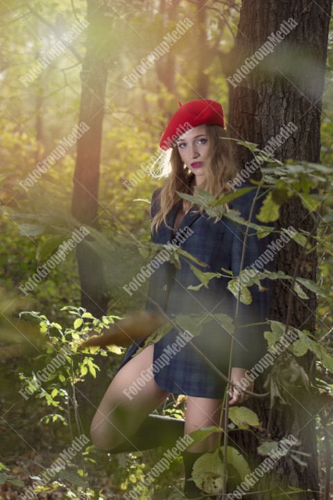 Blonde young woman dressed in oversized jacket and red berette