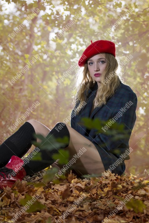 Young woman posing for camera dressed in red berette and big jacket