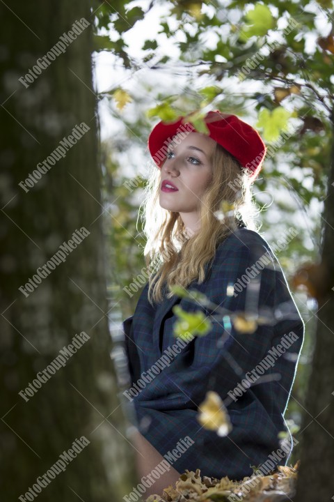 Young woman posing for camera dressed in red berette and big jacket