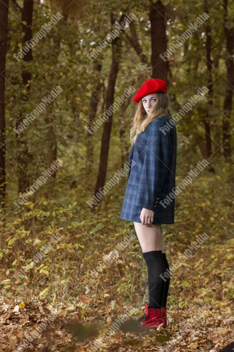 Young woman posing for camera  dressed in red berette and big jacket