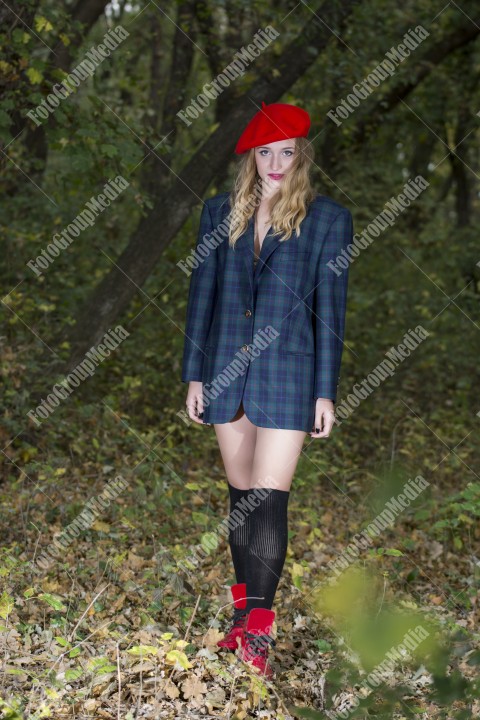 Young woman posing for camera  dressed in red berette and big jacket