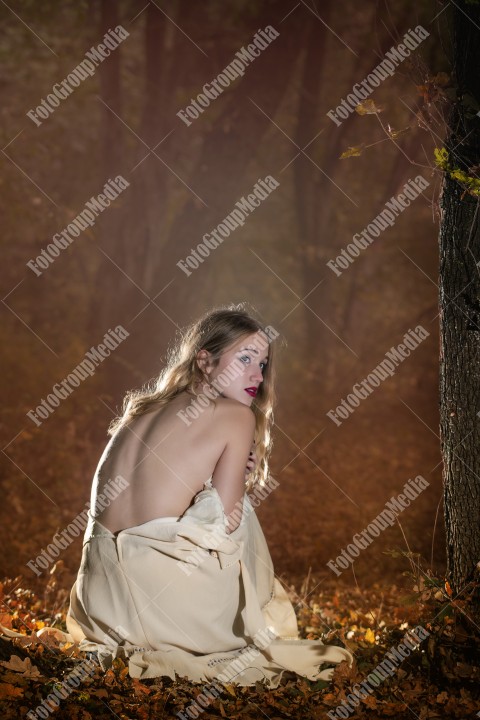 Shy woman covering herself with white dress