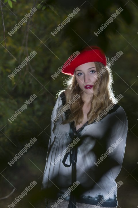 Girl in forest in autumn wearing a red berette