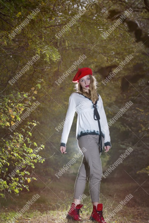 Girl in forest in autumn wearing a red berette