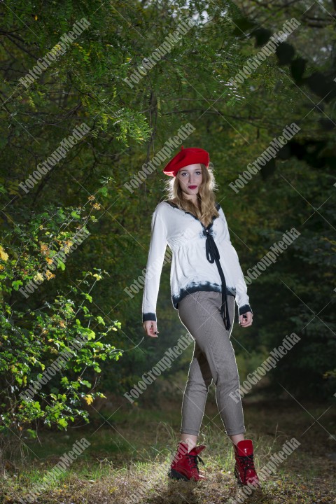 Girl in forest in autumn wearing a red berette