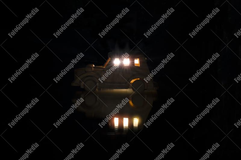 Wood toy car isolated on black background