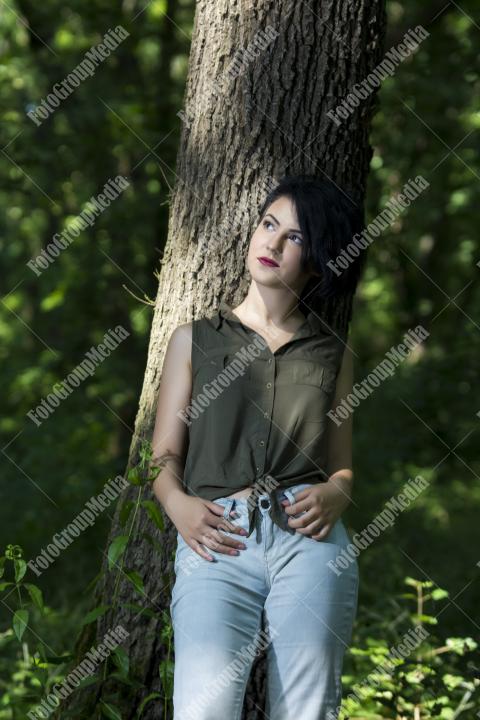 Pretty young girl posing outdoor in a forest