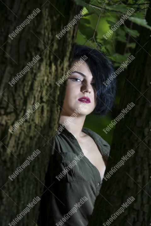 Pretty young girl posing outdoor in a forest