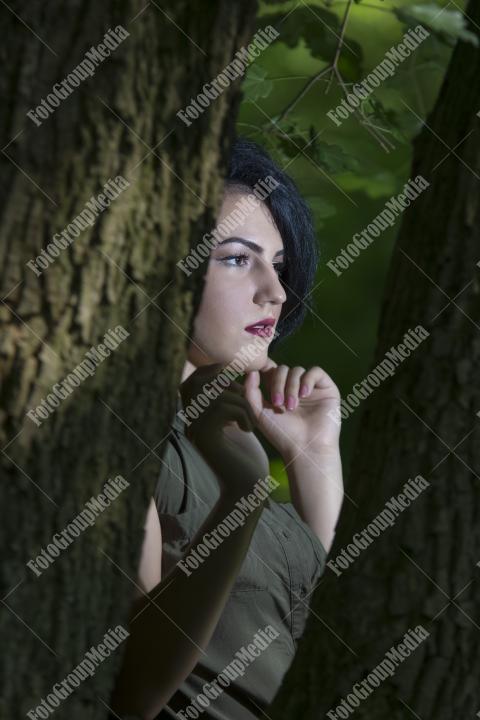 Pretty young girl posing outdoor in a forest