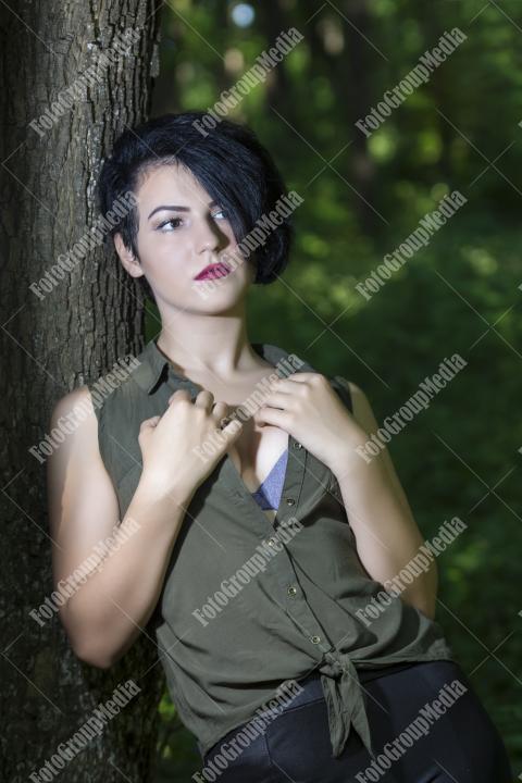 Pretty young girl posing outdoor in a forest