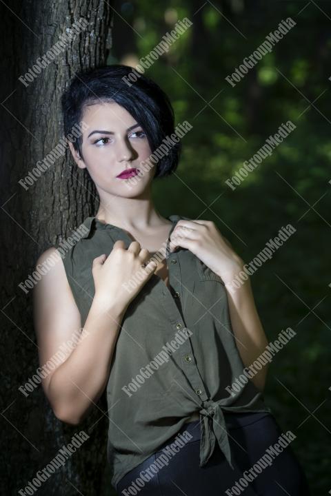 Pretty young girl posing outdoor in a forest