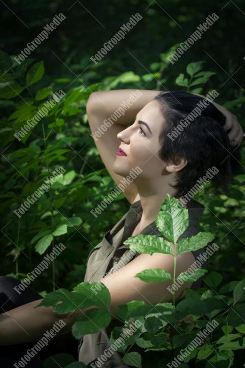 Pretty young girl posing outdoor in a forest