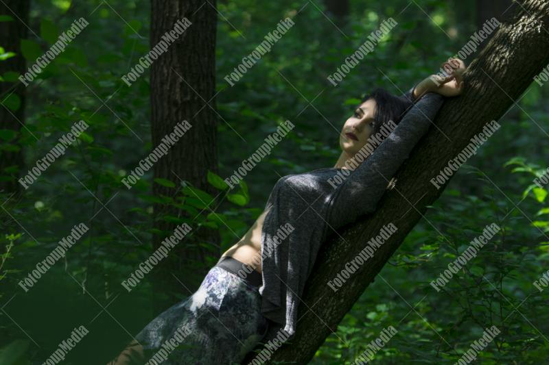 Pretty young girl posing outdoor in a forest