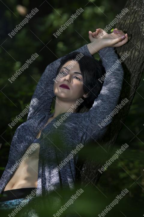 Pretty young girl posing outdoor in a forest