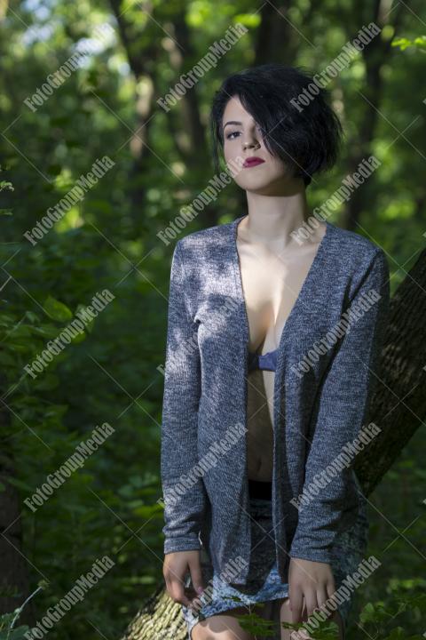 Pretty young girl posing outdoor in a forest