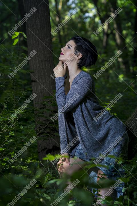 Pretty young girl posing outdoor in a forest