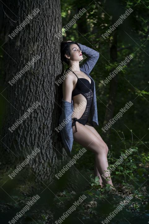 Pretty young girl posing outdoor in a forest