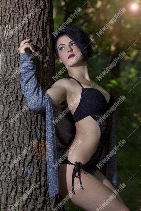 Pretty young girl posing outdoor in a forest