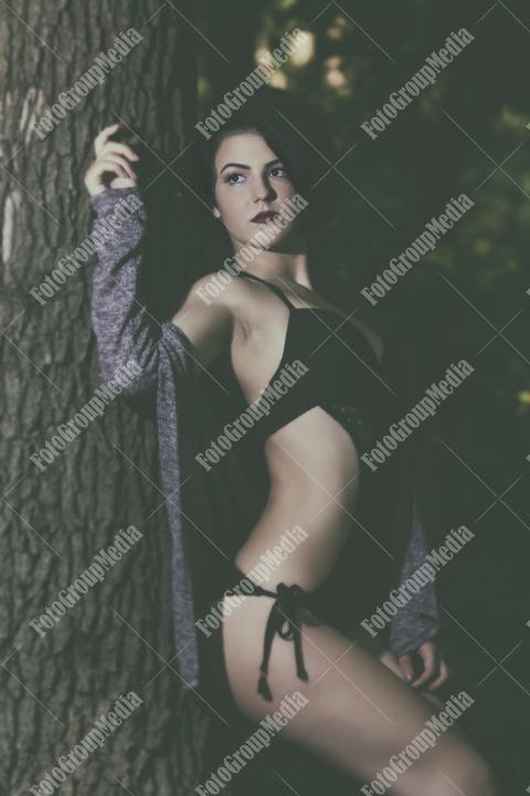 Pretty young girl posing outdoor in a forest