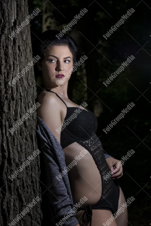 Pretty young girl posing outdoor in a forest
