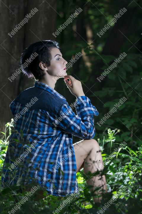 Pretty young girl posing outdoor in a forest