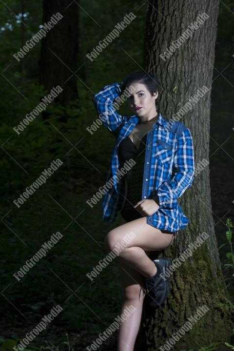 Pretty young girl posing outdoor in a forest