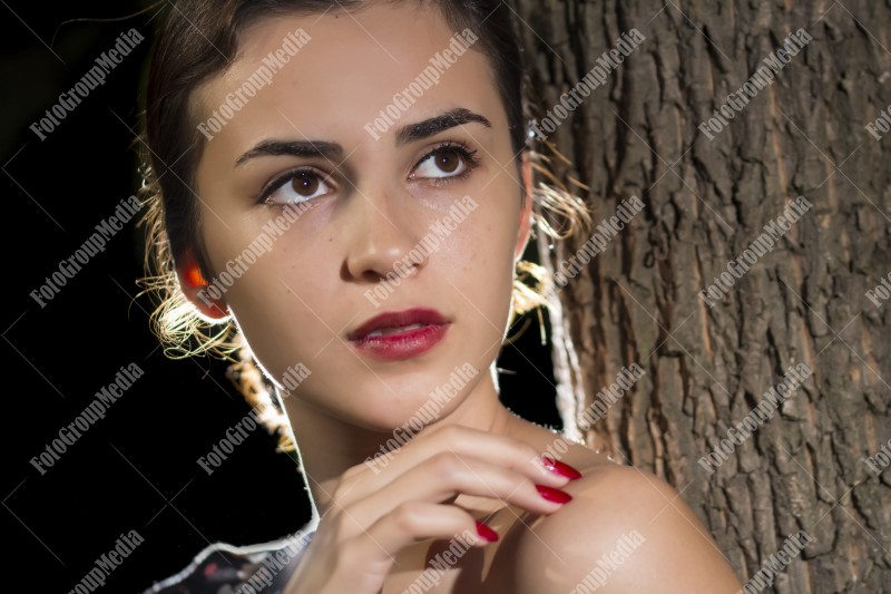 Close up portrait of a young woman, forest background