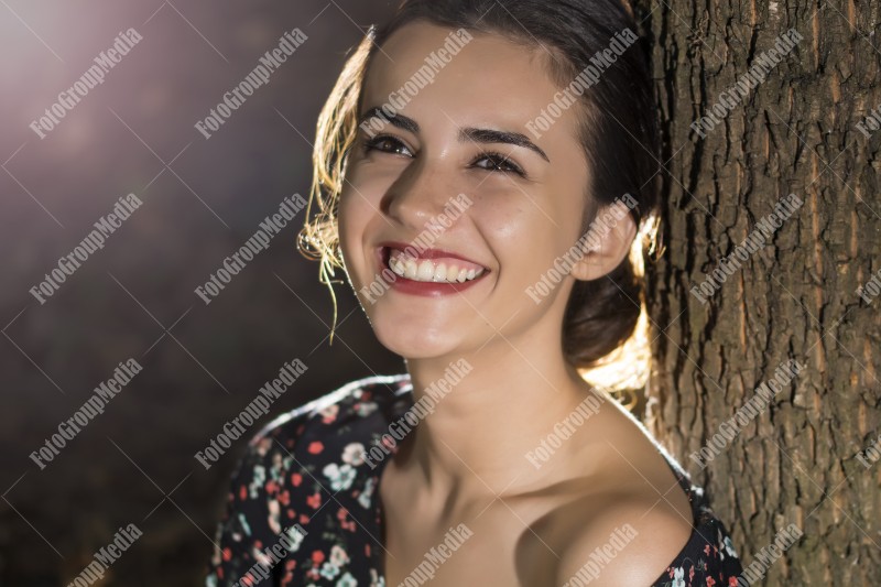 Close up portrait of a young woman, forest background