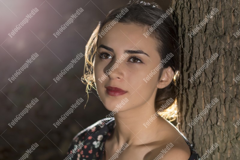 Close up portrait of a young woman, forest background