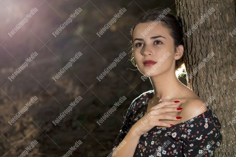 Close up portrait of a young woman, forest background