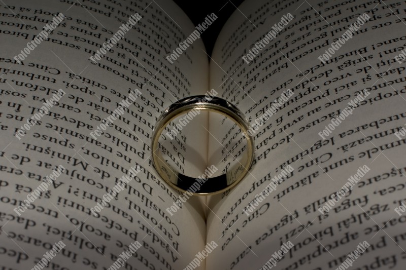 Wedding ring left on open book