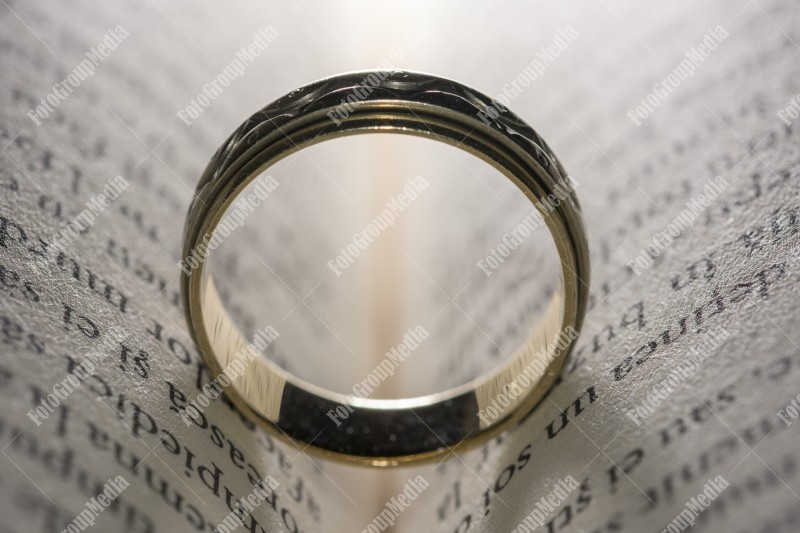 Wedding ring left on open book