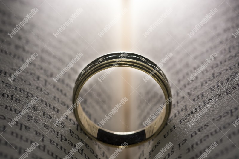 Wedding ring left on open book