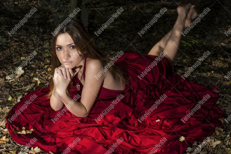 Red dress, a vibrant splash of color on a green forest background