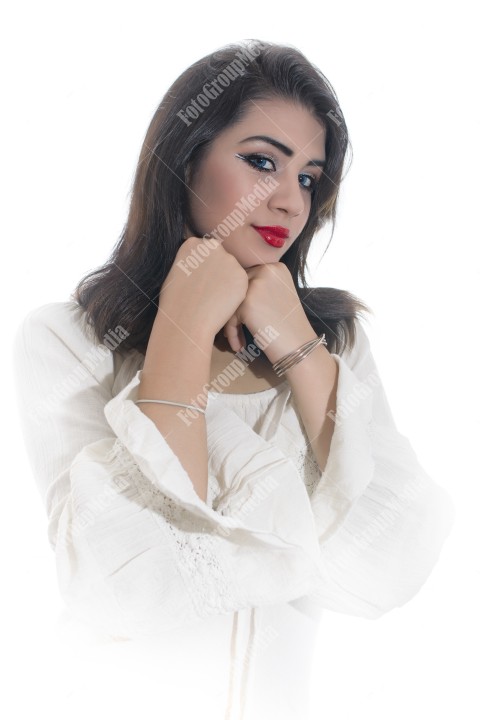 Fashion model posing in studio wearing white dress