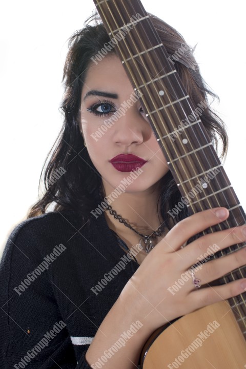 Brunette young girl and guitar, studio shoot