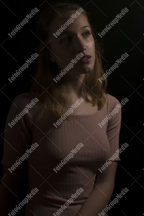 Portrait of a beautiful young woman on black bacground