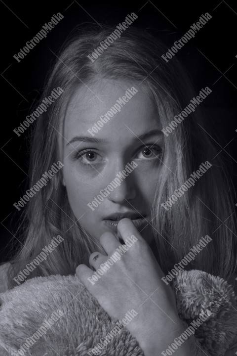 Portrait of a beautiful young woman on black bacground