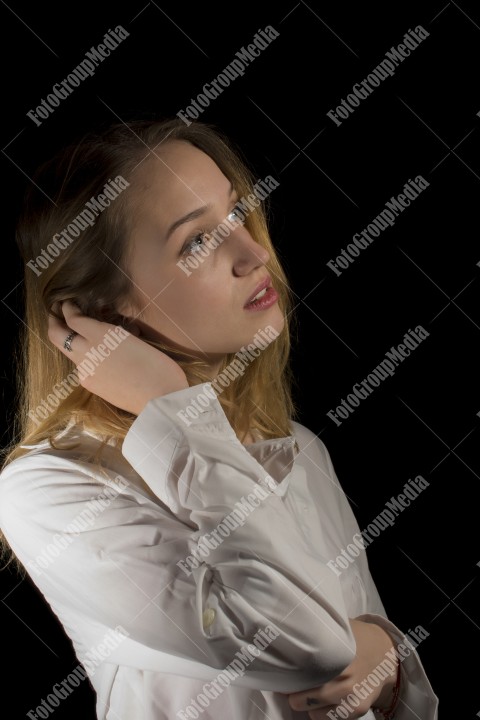 Gorgeous blonde model with white shirt on black background in studio photo