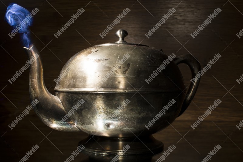 Old kettle isolated on black background