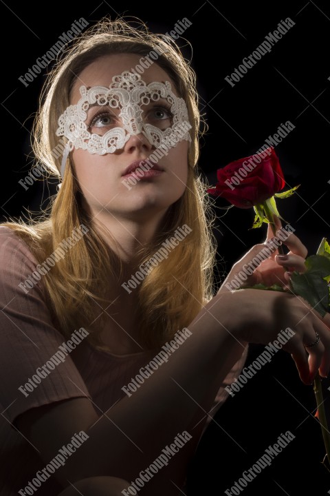 Portrait of a mysterious attractive woman on black background