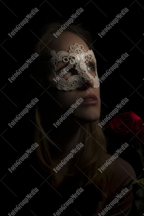 Portrait of a mysterious attractive woman on black background