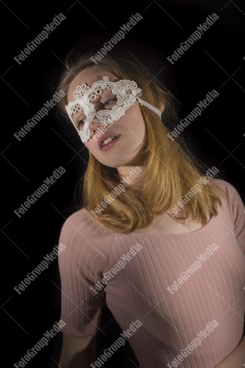 Posing for camera wearing lace mask