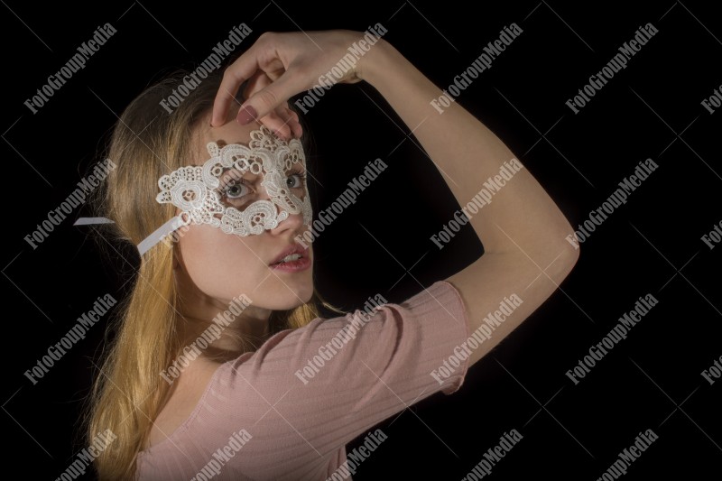 Posing for camera wearing lace mask