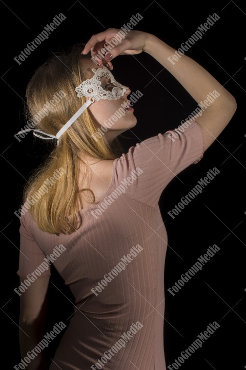 Posing for camera wearing lace mask