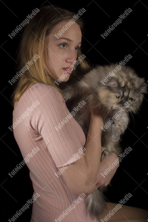 Young beautiful girl hugging her fluffy cat