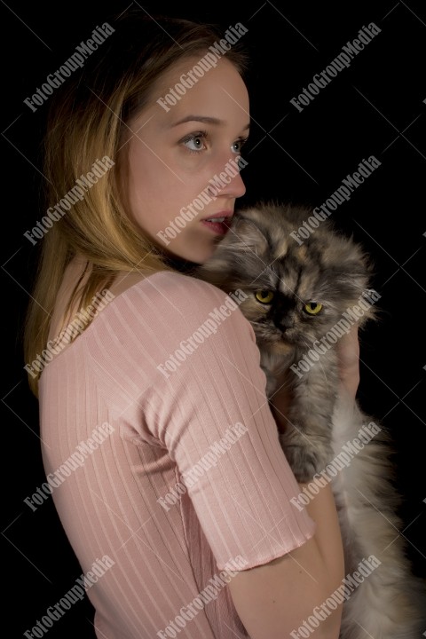 Young beautiful girl hugging her fluffy cat